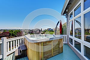 Close-up of wooden hot tub. Luxury house exterior. photo