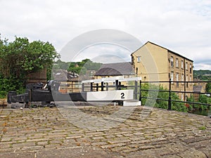 Close up of wooden lock gates on the calder hand hebble navigation canal in front of the basin in sowerby bridge west yorkshire