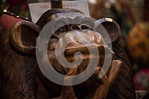 Close up of wooden monkey sculpture with curious face