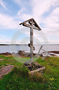 Close-up of a wooden Orthodox cross on a summer evening against the White sea, Russia