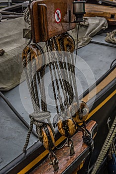 Close up of wooden pully blocks securing the rigging on sail boa