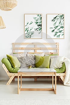 Wooden sofa with green cushions