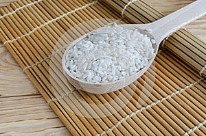 Close-up of a wooden spoon filled with rice