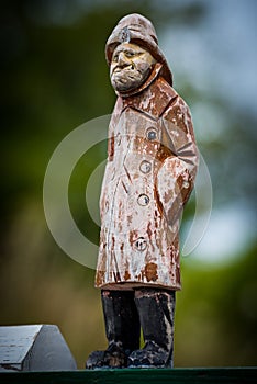 Close up of a wooden statue of a fisherman