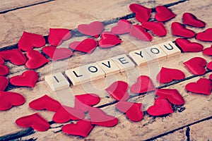 Close up wooden text for I LOVE YOU and Red heart on wood background.