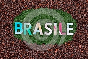 Close up of word Brasile on grass with coffee beans around photo