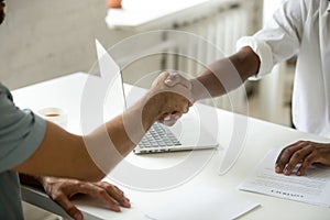 Close up of work employer shaking hand of job applicant