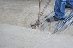 Worker bending steel with steel bending equipment by hand photo