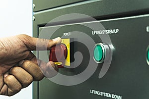Close up of Worker hand twist main power switch before operating machine