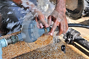 Close-up of worker hands plumbing unscrew connecting pipe while