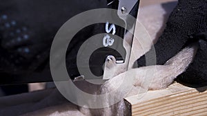 Close up for worker hands in protective glass stitching thermal insulation material with aconstruction stapler to the