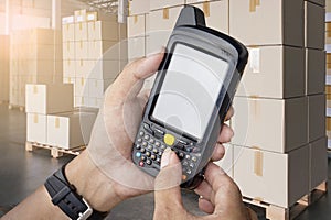 Close-up, Worker holding barcode scanner his checking shipment boxes. Computer equipment for warehouse inventory management.