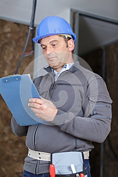 close-up worker inspector holding clipboard