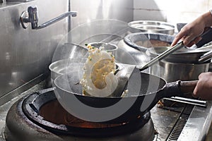 Close up of working chef preparing chinese food