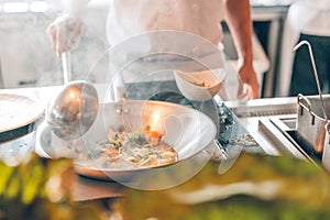 Close up of working chef preparing Chinese food, Food frying in wok pan. Sale and food concept