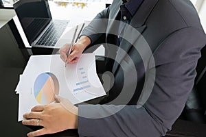 Close up working desk of young businessman manager who is working in professional career for analysing data and information to