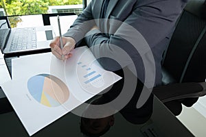 Close up working desk of young businessman manager who is working in professional career for analysing data and information to