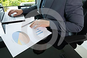 Close up working desk of young businessman manager who is working in professional career for analysing data and information to