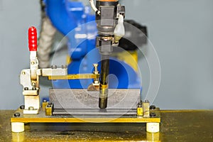 Close up workpieces set up tee joint on table for electric mig welding process by robot at factory photo