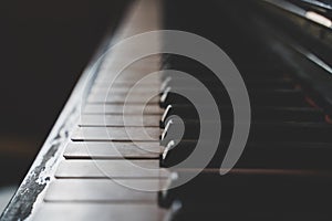 Close up of worn old piano keys with a shallow depth of field