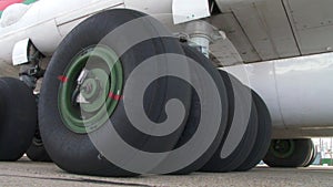 Close up worn tires of a passenger plane at the airfield. shot of the chassis of a large passenger liner from the outside of the m