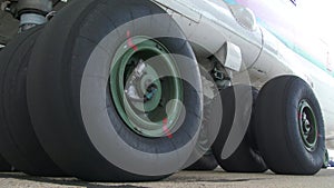 Close up worn tires of a passenger plane at the airfield. shot of the chassis of a large passenger liner from the outside of the m