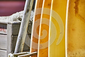 Close-Up of Worn Yellow Surfboards at Rustic Beachside