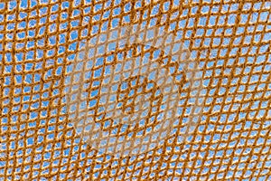 Close-up of a woven net or mesh pattern with detailed texture, grid structure