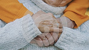 Close up wrinkled hands. Happy old couple hugging in park. Senior man flirting with elderly woman. Romance at old age