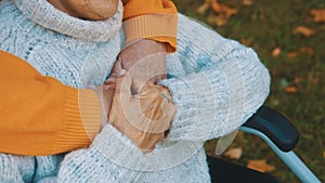 Close up wrinkled hands. Happy old couple hugging in park. Senior man flirting with elderly woman. Romance at old age