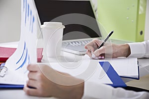 Close up of writing businesswomanï¿½s hands