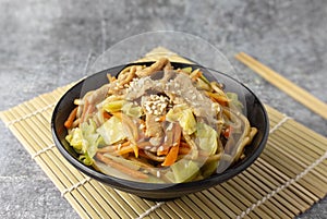 Close up Yakisoba noodle with pork, Japanese food in a black bowl