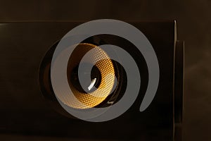 Close up of yellow audio woofer at dark background