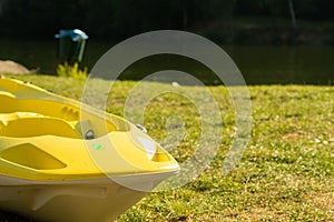 Close-up of yellow boat on green grass