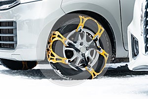 Close-up of yellow chains anti-slip wheel chain. There are fitted to the tires of vehicals to provide maximum traction when