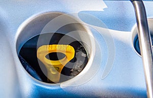 Yellow dipstick oil in a car engine