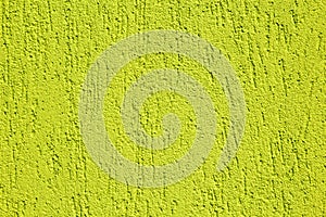 Close up of a yellow-green dragged plaster wall. photo