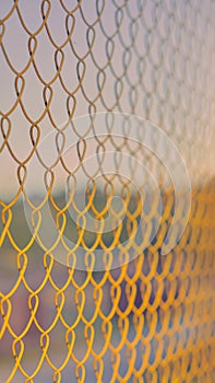 Close up of yellow metal grid on the soft colors of sky