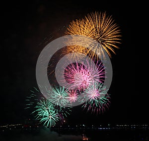 Close-up of yellow, pink and green fireworks display