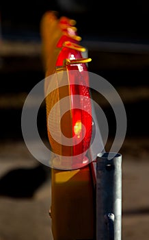 Close-up of yellow and red warning lights seen from the side