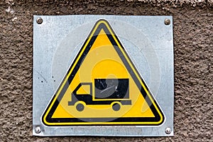 Close up yellow sign with image of truck