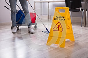 Close-up Of Yellow Wet Floor Caution Sign