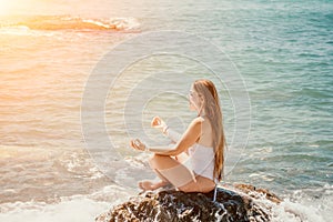 Close up Yoga Hand Gesture of Woman Doing an Outdoor meditation. Blurred sea background. Woman on yoga mat in beach