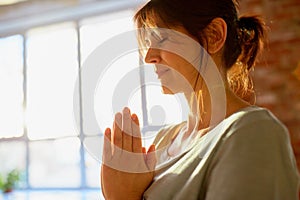 Close up of yogi woman meditating at yoga studio