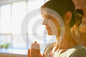 Close up of yogi woman meditating at yoga studio