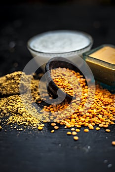 Close up of yogurt or curd face pack with honey,lemon juice,turmeric powder for acne skin on wooden surface in a glass container