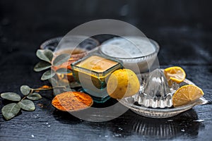 Close up of yogurt or curd face pack with honey,lemon juice,turmeric powder for acne skin on wooden surface in a glass container w