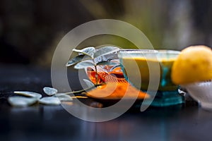 Close up of yogurt or curd face pack with honey,lemon juice,turmeric powder for acne skin on wooden surface in a glass container w