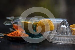 Close up of yogurt or curd face pack with honey,lemon juice,turmeric powder for acne skin on wooden surface in a glass container w