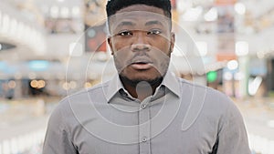 Close-up young african american man wearing protective mask looking at camera happy confident guy taking off medical